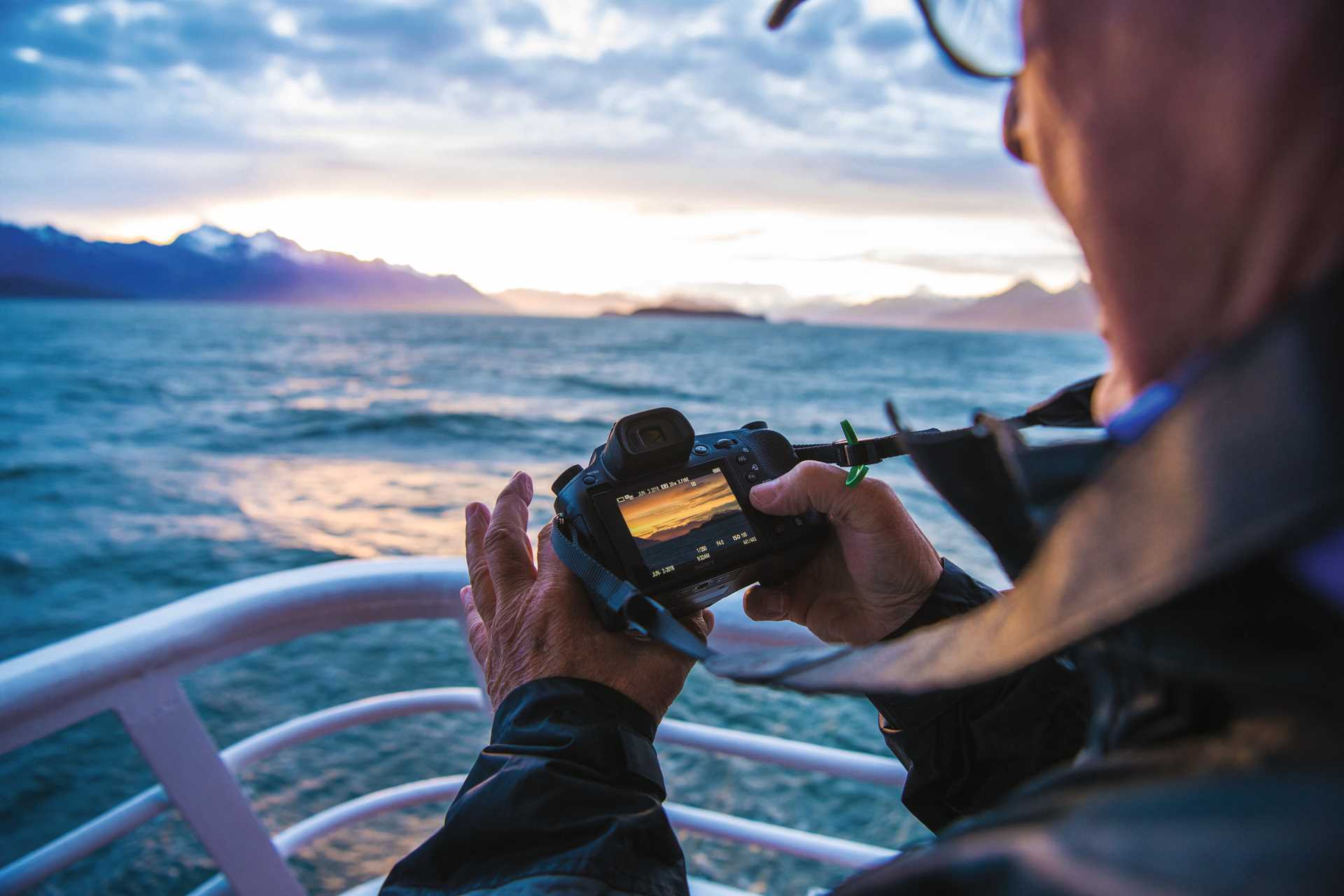 A photographer captures the sunset aboard the National Geographic Sea Bird, near Haines, Alaska