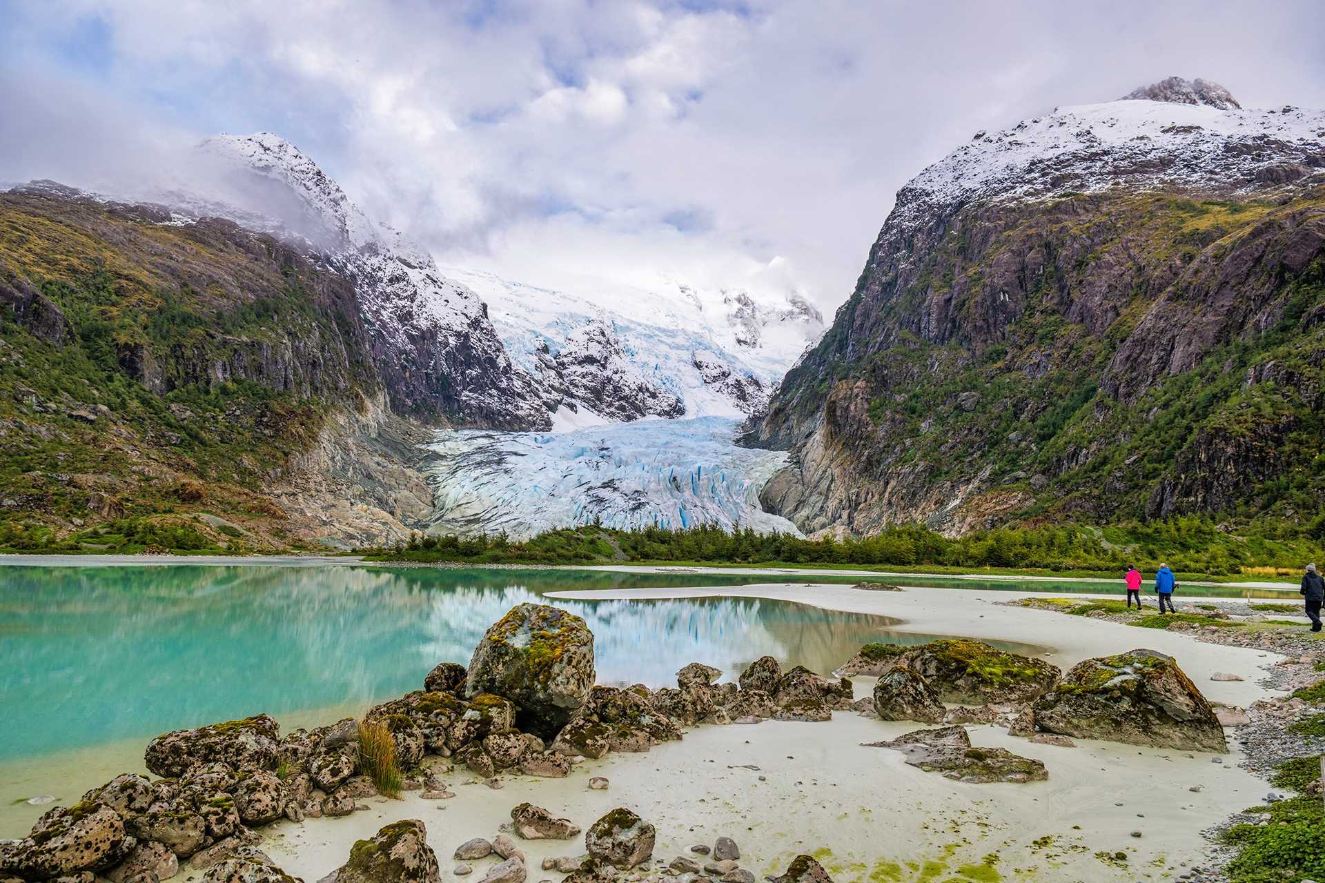 Three guests far off hike towards Bernal Glacier in Patagonia