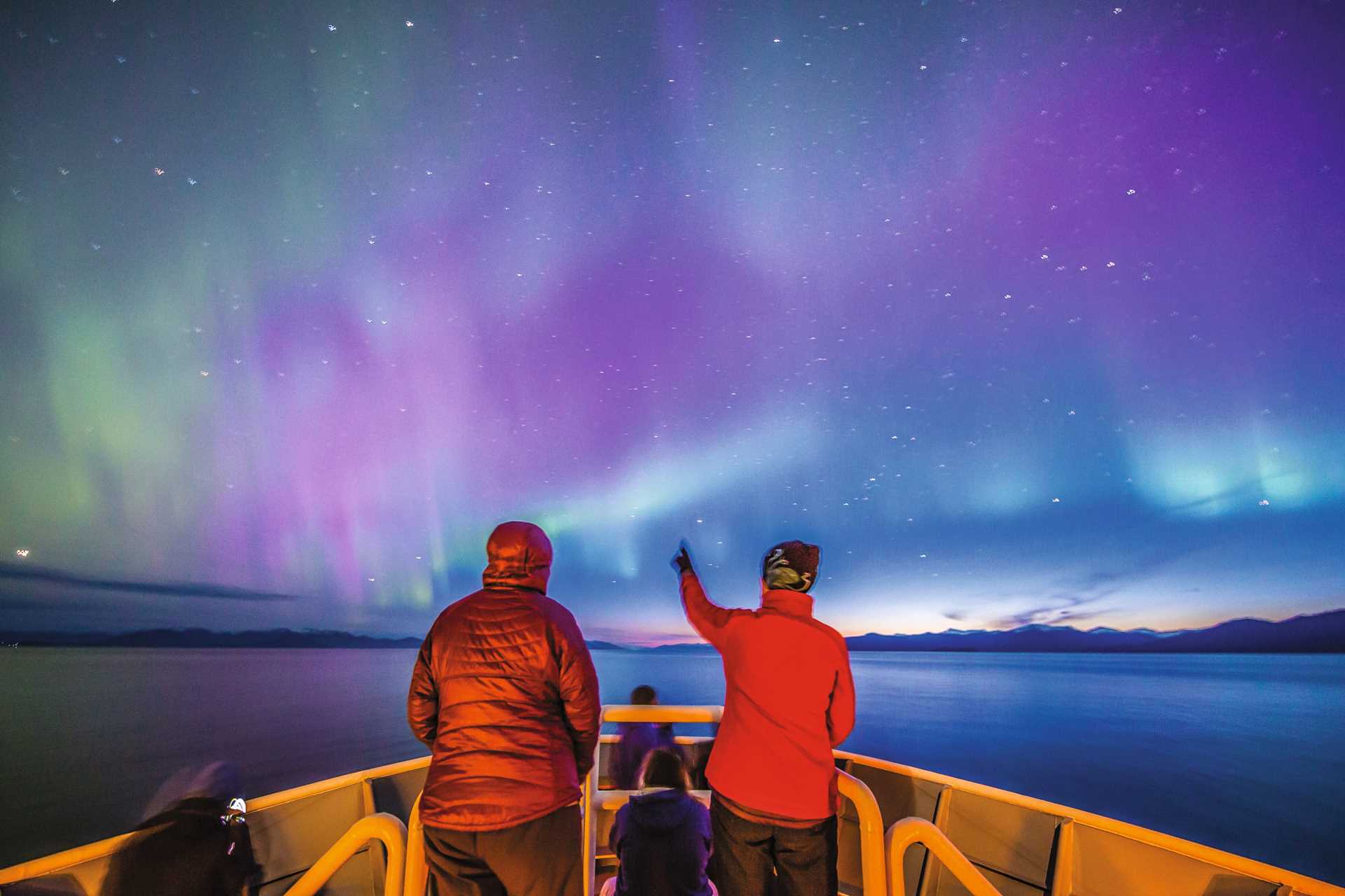 Guests watch the Northern lights from the National Geographic Sea Bird in Frederick Sound, Alaska.