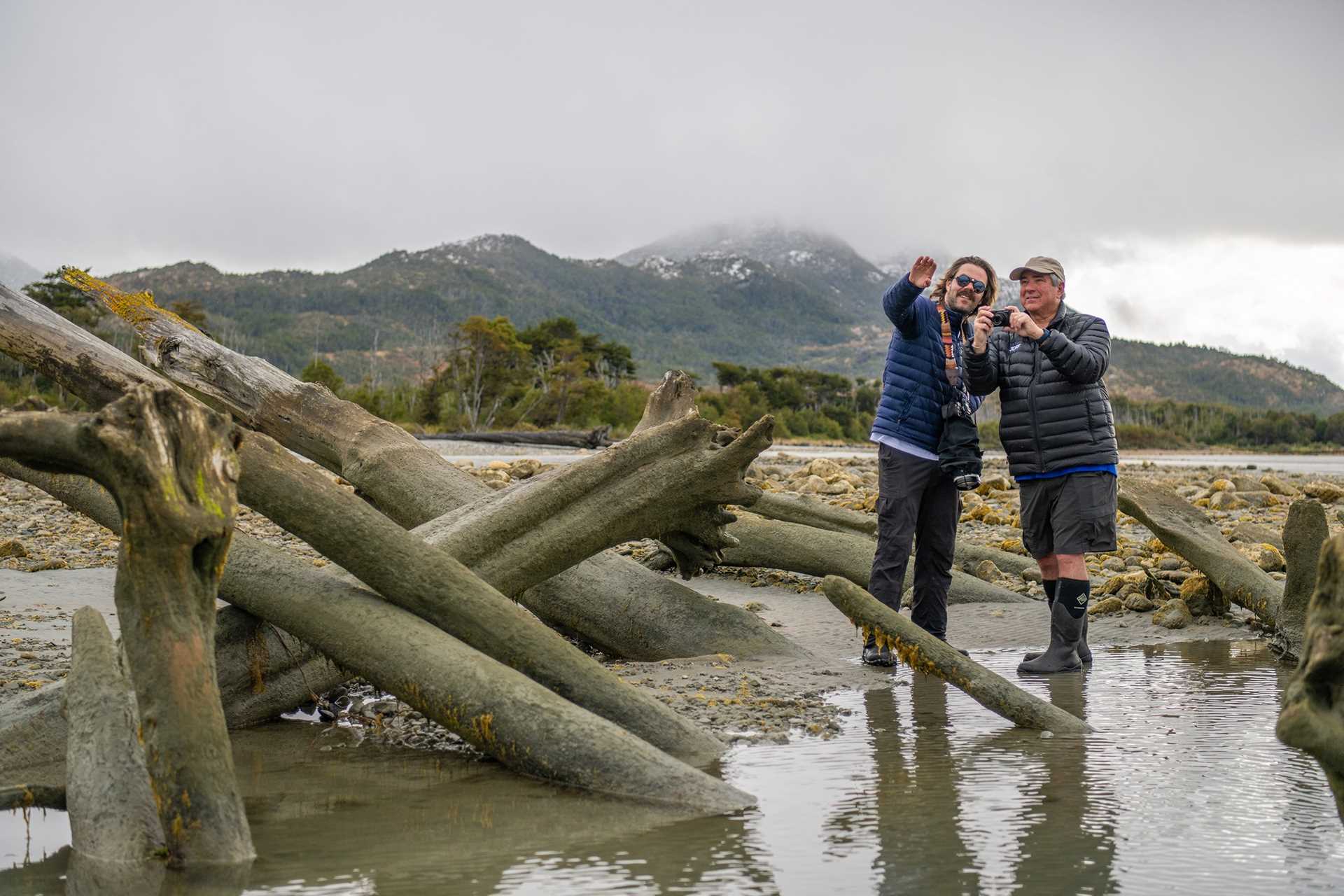 Certified photography instructor Jayden O'Neill helps a male guest photograph Jackson Bay, Karukina Natural Park, Patagonia.
