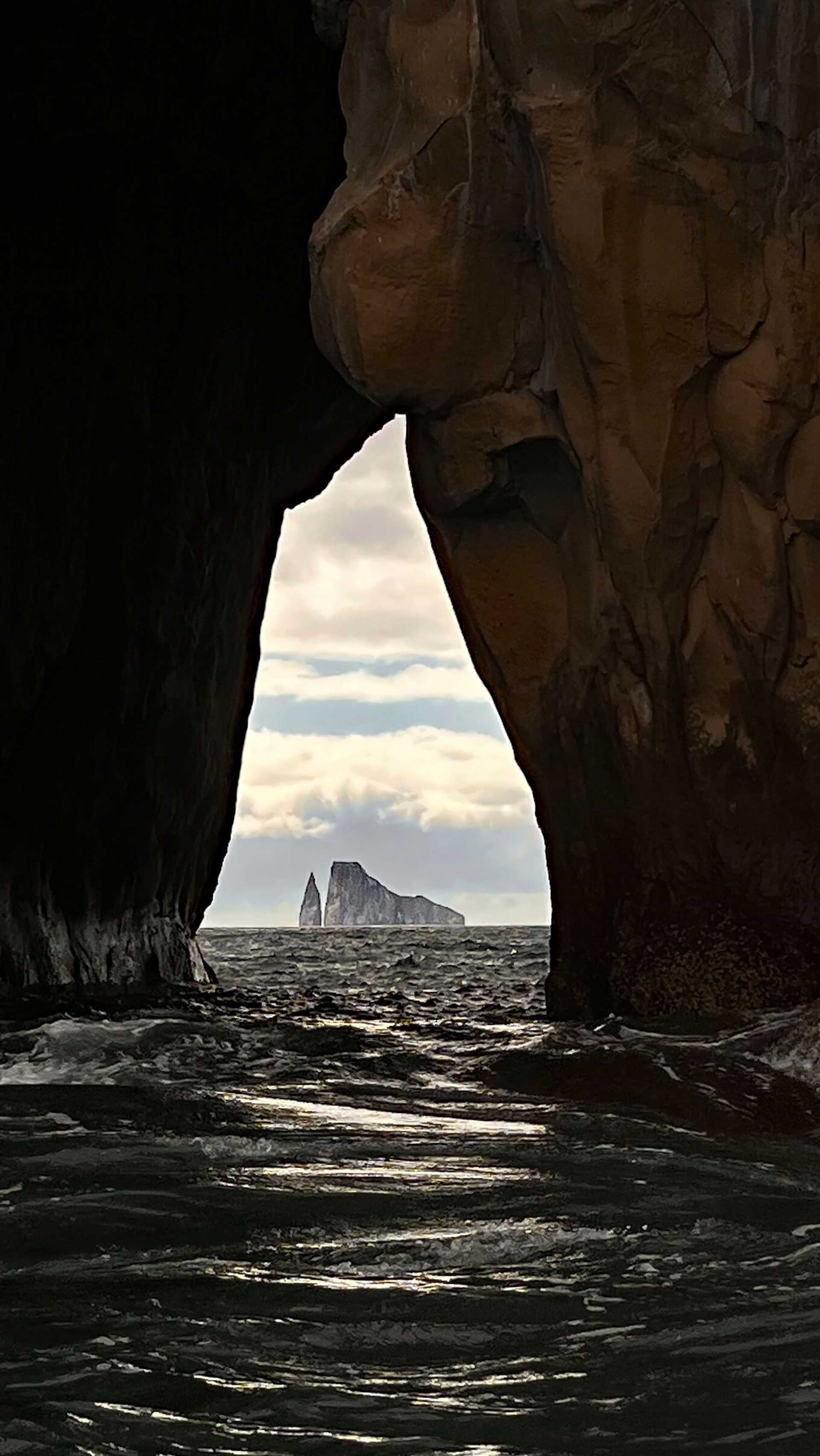 a rock formation framed by two large rock walls