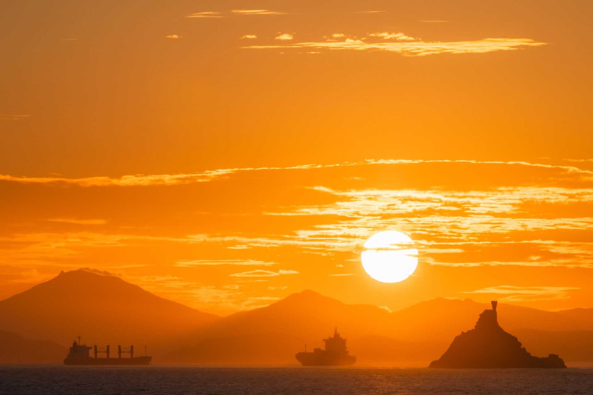 sunset over boats at sea